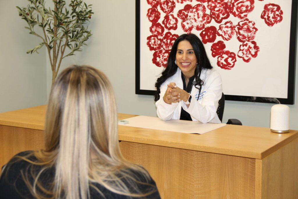 Dr. Nadia Sirdar speaking with a patient in her Bethesda primary care office.