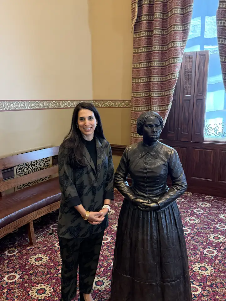 Dr. Nadia Sirdar beside the Harriet Tubman statue in the Maryland State House
